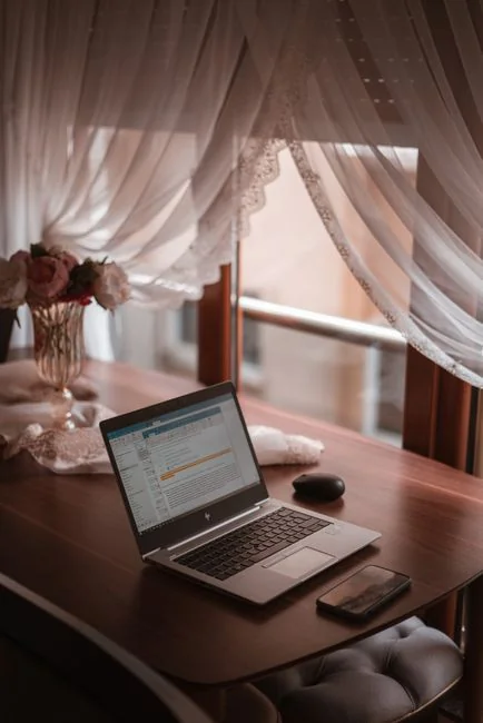 a-person-using-a-laptop-computer-on-a-desk-9imwtlr1wvi